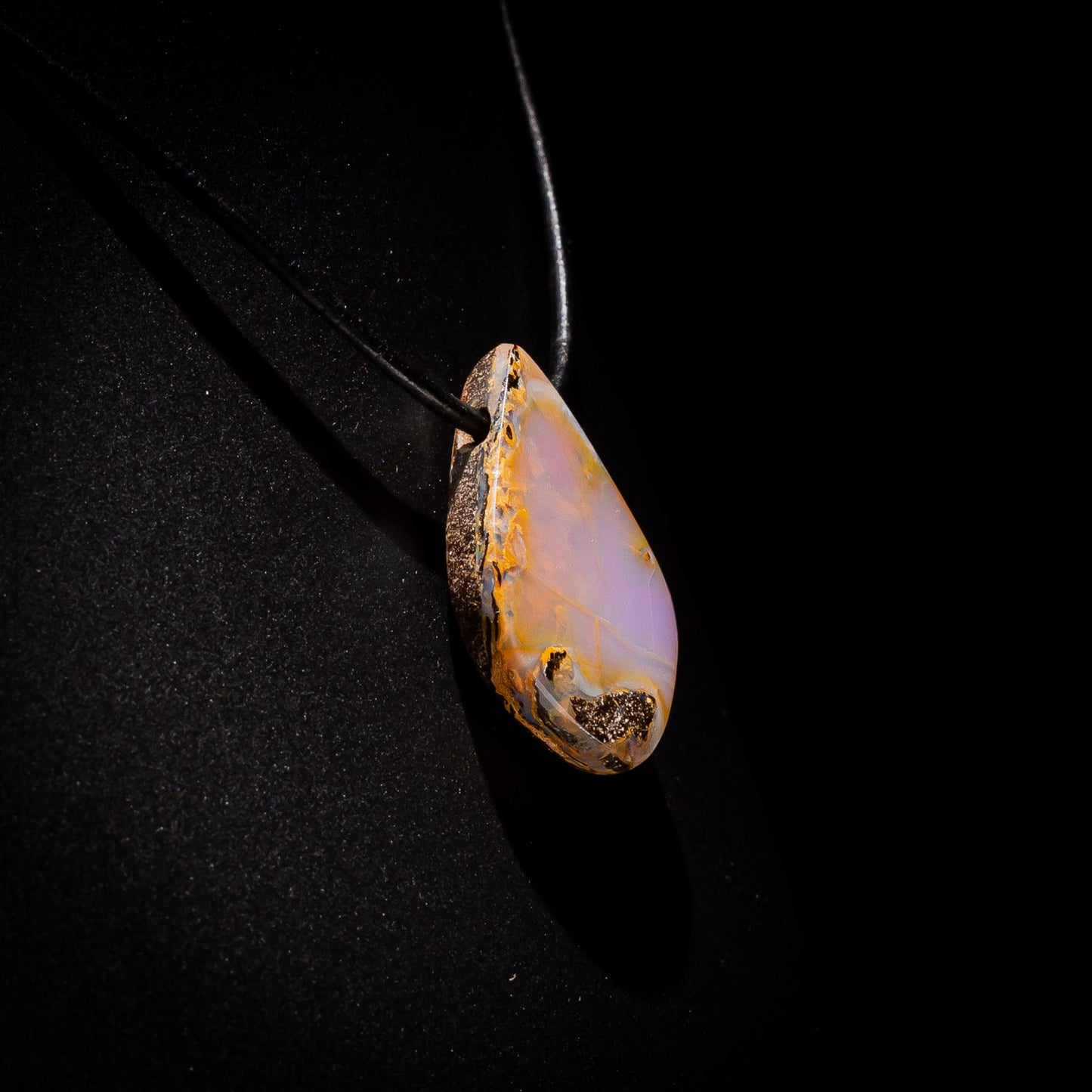 Australian Boulder Opal on leather