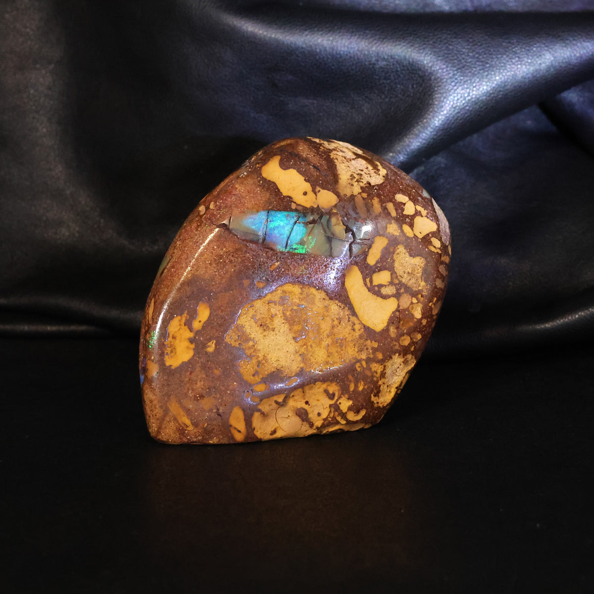 Opal specimen sparks of color in sandy iron stone