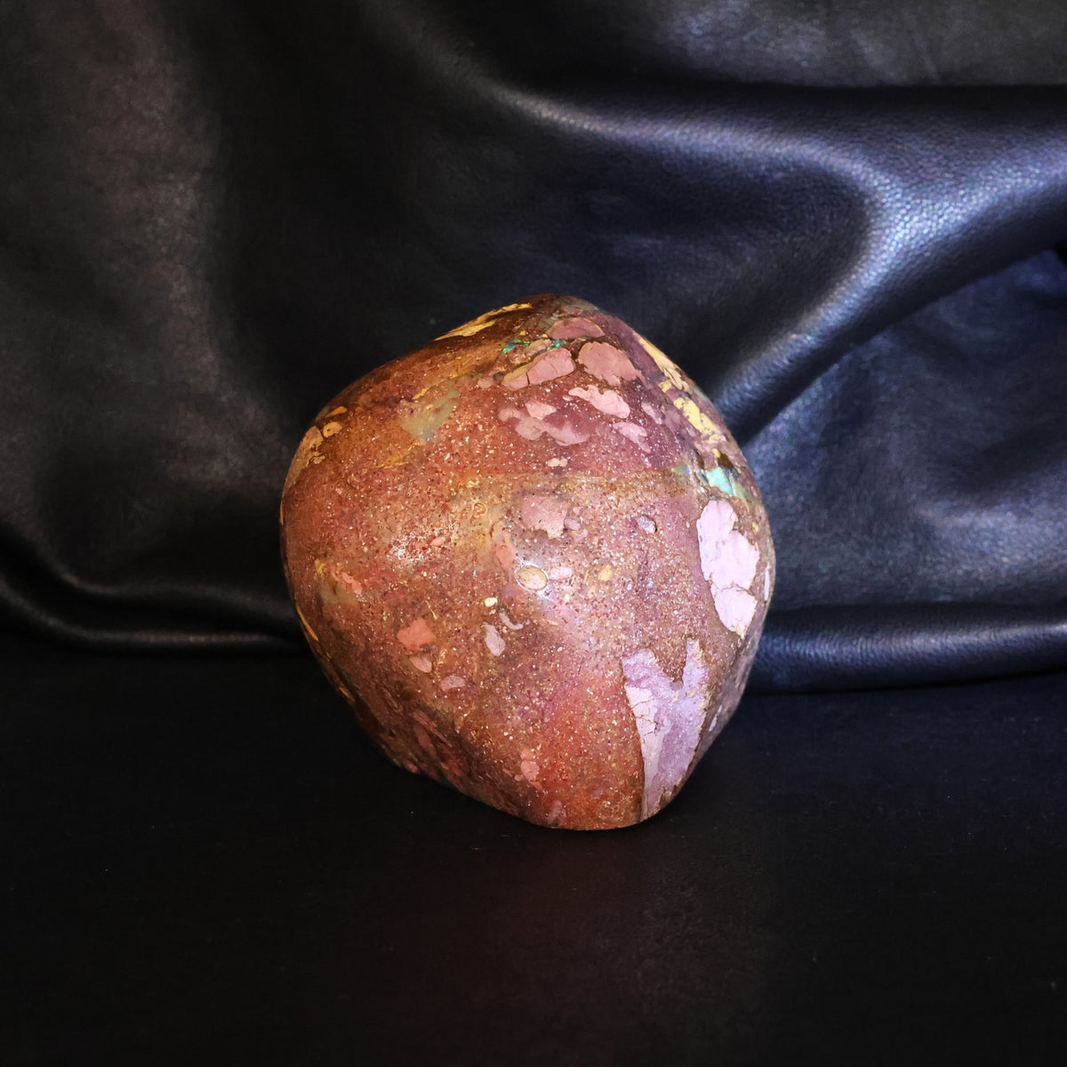 Opal specimen sparks of color in sandy iron stone