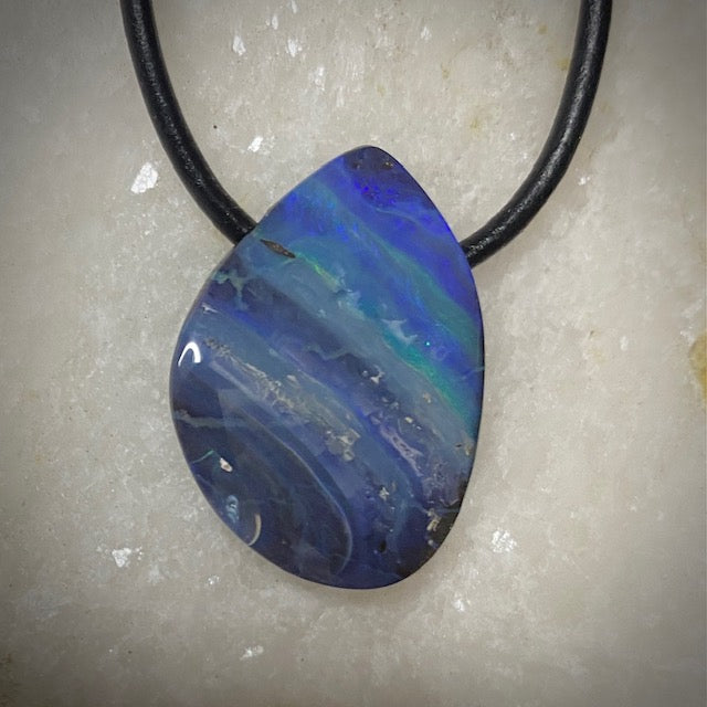 Australian Boulder Opal on leather 