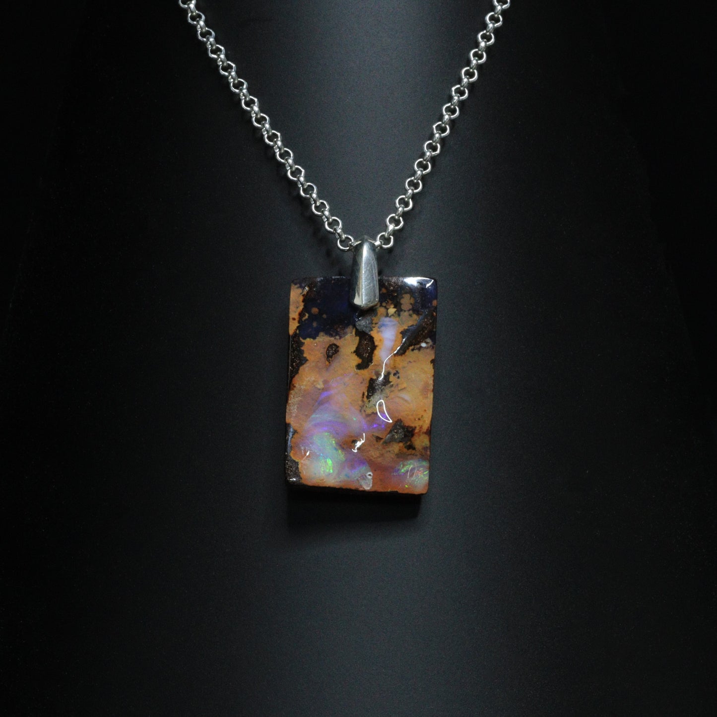 Australian Boulder Opal on leather 