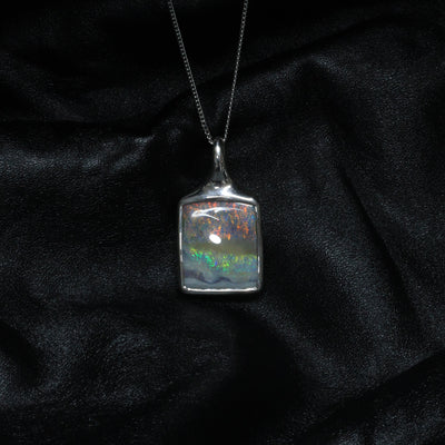 Australian Boulder opal is an opal that has the host ironstone rock forming naturally as part of the gem. There are often inclusions in the opal layer and because the layer follows the contours of natural ironstone the shape is often much undulated. The irregular shape of boulder opal makes it a designer’s delight and most pieces of jewelry using boulder opal are very unusual.
