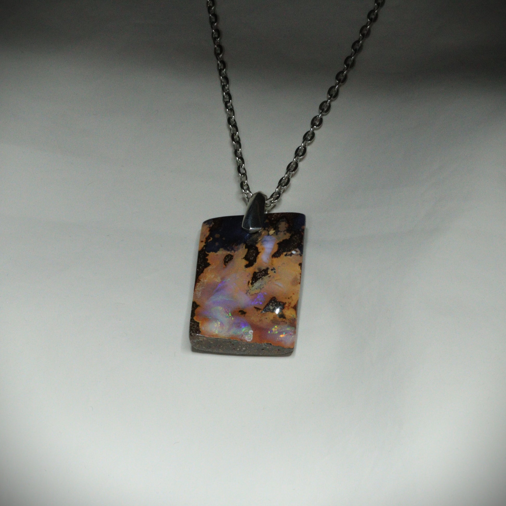 Australian Boulder Opal on leather 