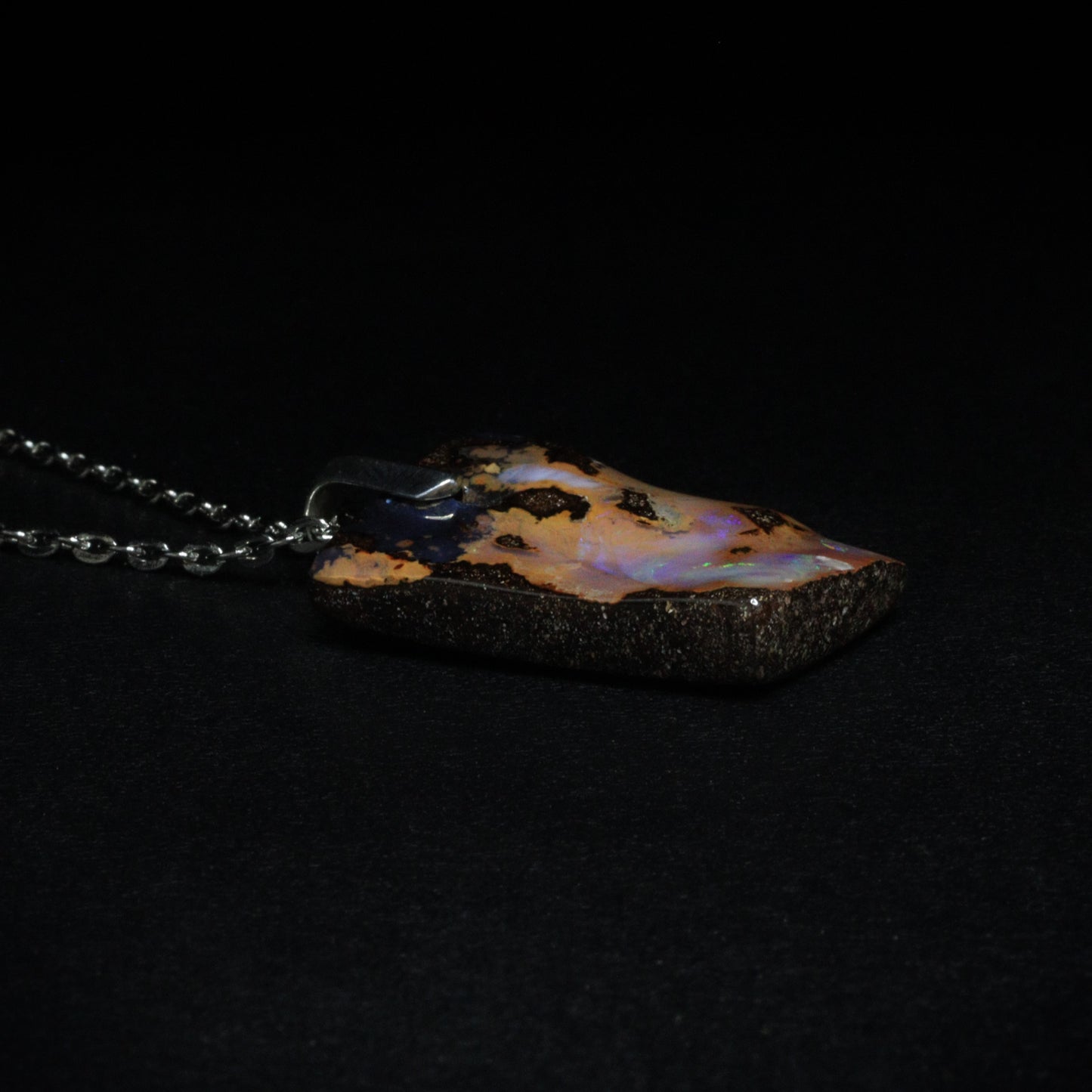 Australian Boulder Opal on leather 