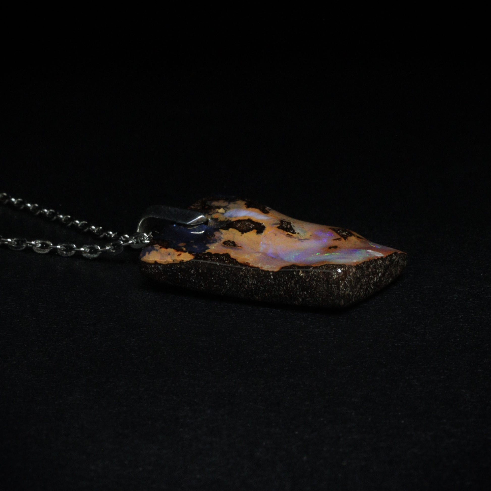 Australian Boulder Opal on leather 