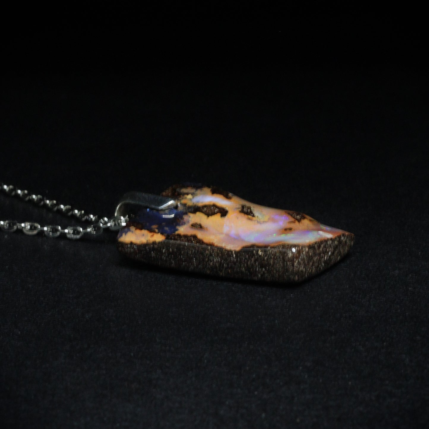 Australian Boulder Opal on leather 