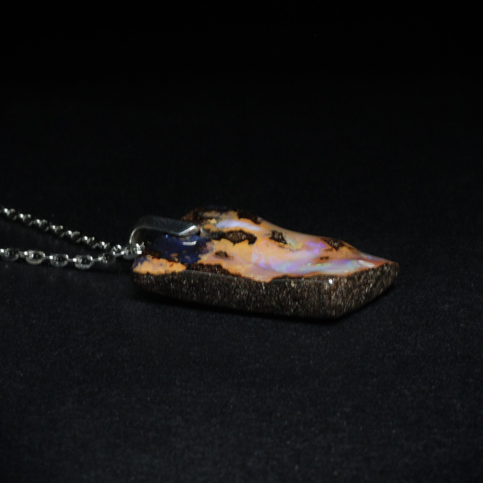 Australian Boulder Opal on leather 