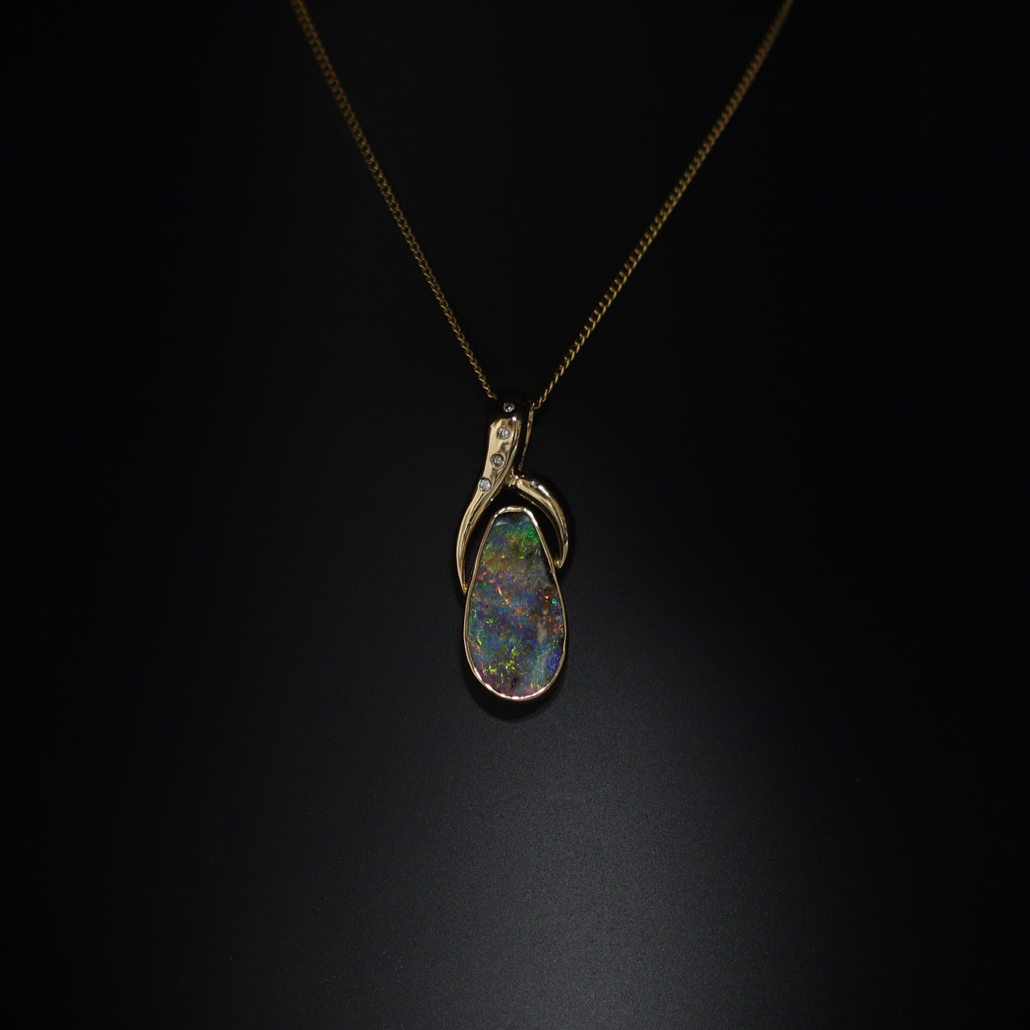 Australian Boulder opal set in 18 K gold pendant