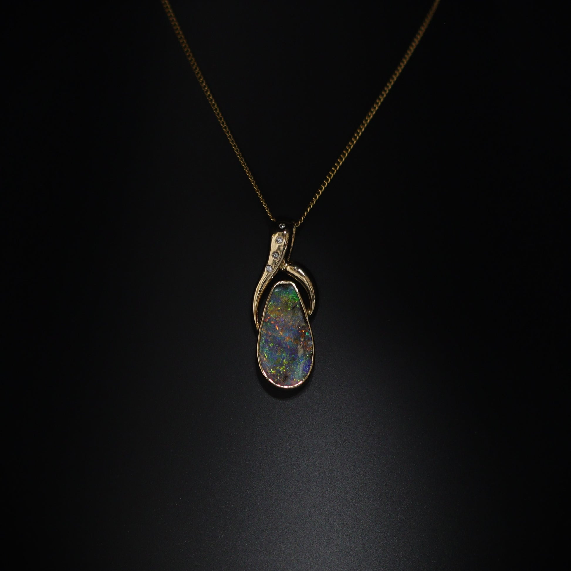 Australian Boulder opal set in 18 K gold pendant