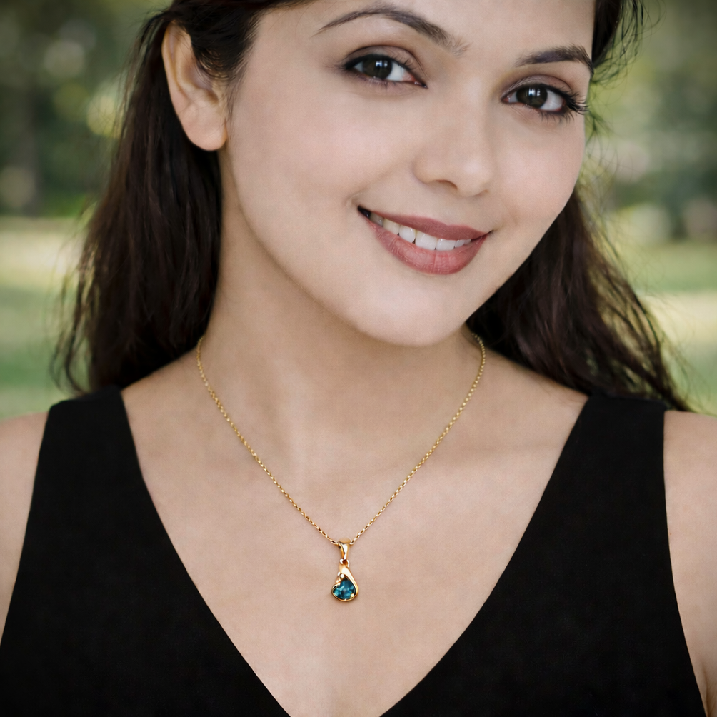 Black Opal pendant showing broadflash green-blue colour play in 18K yellow gold asymmetric setting — detail view