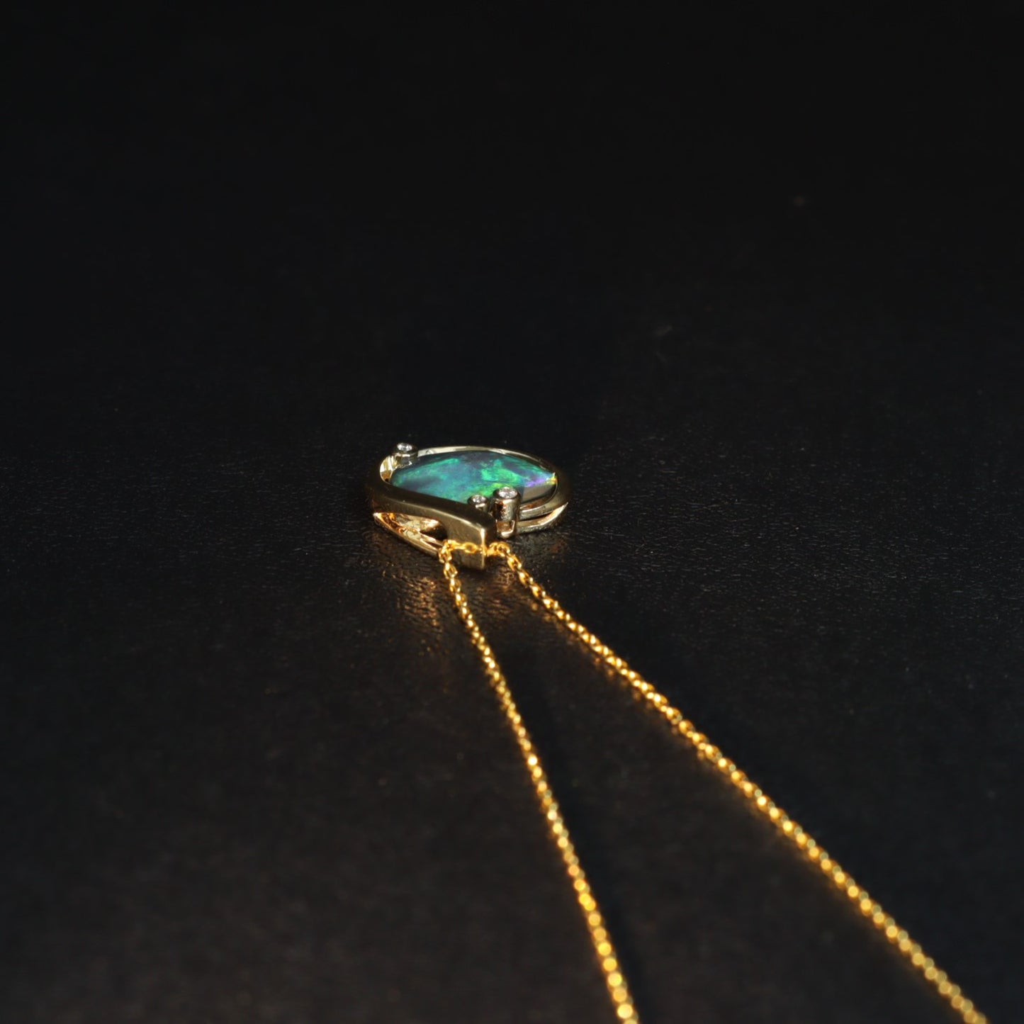 Lightning Ridge Black Opal pendant in 18K gold — side profile of free-form oval setting