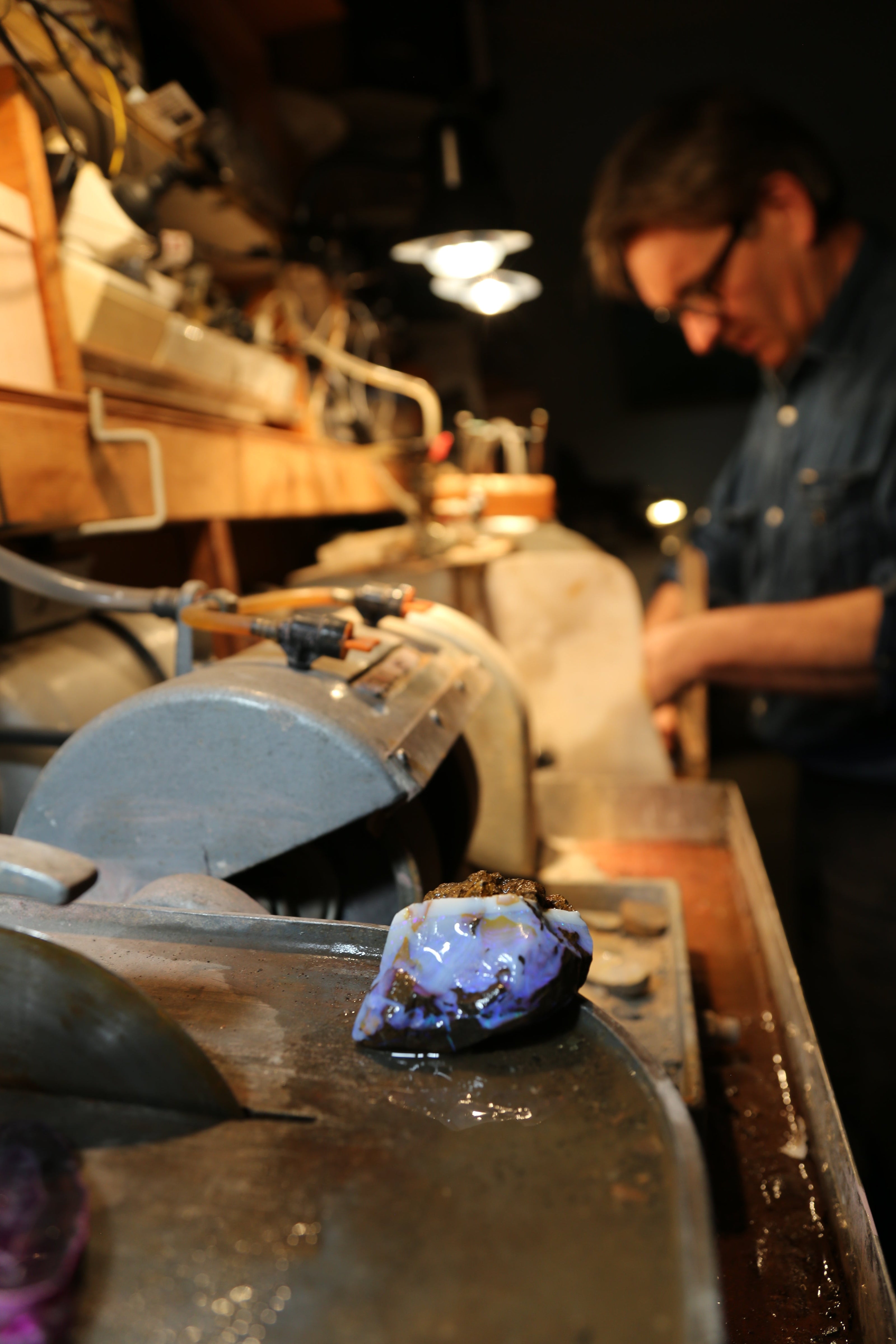 Joseph polishing an Australian opal at his workshop — Rocks On The Rocks, Sydney