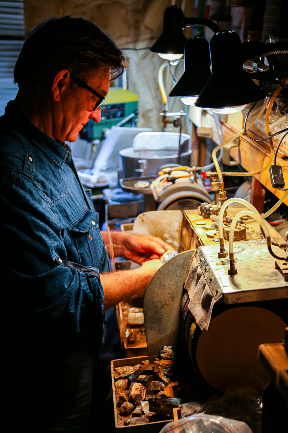 Joseph polishing an Australian opal by hand — Rocks On The Rocks, Sydney