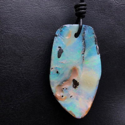 Australian Boulder opal is an opal that has the host ironstone rock forming naturally as part of the gem. There are often inclusions in the opal layer and because the layer follows the contours of natural ironstone the shape is often much undulated. The irregular shape of boulder opal makes it a designer’s delight and most pieces of jewelry using boulder opal are very unusual.